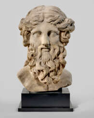 AN OVER-LIFESIZED ROMAN MARBLE BUST OF A BEARDED DEITY