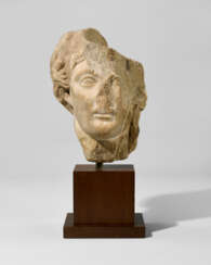 A ROMAN MARBLE HEAD OF A DEITY