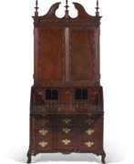 Storage furniture. A CHIPPENDALE CARVED MAHOGANY BLOCK-FRONT DESK-AND-BOOKCASE