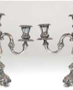 Product catalog. Paar Kandelaber, 830er Silber, punziert, 3-flammige Barock-Form, gefüllter quadratischer Stand, H. 28 cm