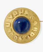Brooches and pins. A brooch with ceramic cabochon