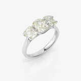 A classic eternity ring set with three diamonds in a modified cushion cut - photo 1