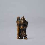 A CARVED WOOD NETSUKE OF HAN KAI (FAN KUAI) CARRYING A SHIELD - photo 1