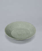 Dinnerware. A LOBED CELADON STONEWARE DISH WITH MOLDED PEONY DESIGN