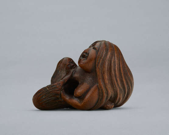 A CARVED WOOD NETSUKE OF A MERMAID HOLDING HER CHILD - photo 2