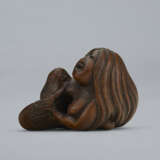 A CARVED WOOD NETSUKE OF A MERMAID HOLDING HER CHILD - photo 2