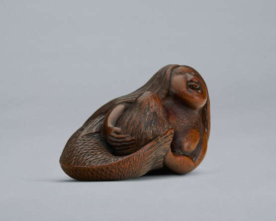 A CARVED WOOD NETSUKE OF A MERMAID HOLDING HER CHILD - photo 3