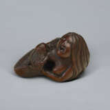 A CARVED WOOD NETSUKE OF A MERMAID HOLDING HER CHILD - photo 5