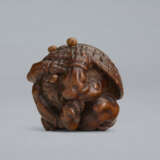 A CARVED WOOD NETSUKE OF A ONI UNDER HAT - фото 4