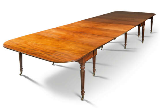 A REGENCY MAHOGANY CONCERTINA-ACTION DINING-TABLE - photo 1