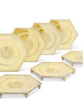 A SET OF SEVEN QUEEN ANNE SILVER-GILT SALVERS