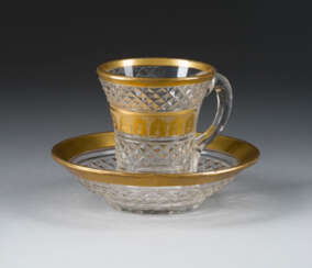 A GLASS CUP WITH SAUCER