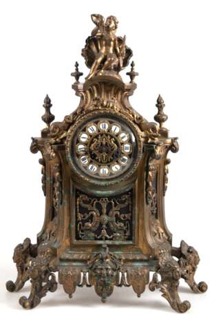 Historismus-Pendule, reich verziertes Bronze-Gehäuse mit Maskaron und Meeresfabelwesen, auf 4 figürlichen Füßen, Putto mit Muschelhorn als Bekrönung, 1/2-Stundenschlag auf Glocke, Pendel mit Blattfederaufhängung, läuft a… - фото 1