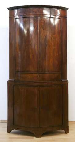 Biedermeier-Eckschrank, Mahagoni furniert, viertelrund, 2-türiges Unterteil mit 1 Schubkasten, 2-türiger Aufsatz, gerades Profilgesims, leichte Gebrauchspuren, 217x122x73 cm - photo 1