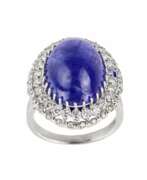 Product catalog. Ring in 18K white gold with tanzanite, cabochon cut, and loose diamonds. 