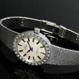 Ensi Weißgold 585 Damenarmbanduhr mit ovaler Brillant Lünette (zus. ca. 0.60ct/SI/W) und Faltverschluss an satiniertem Band, Handaufzug, 38,3g, L. 18,5cm, gangbar (keine Garantie auf Werk und Funktionalität) - фото 1