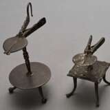2 Antike Schmiedeeisen Wachstock Halter, Deutsch oder Niederlande 18.Jh.: mit quadratischer Platte auf 4 vernieteten Füßchen (H. 10,3cm) und mit runder Bodenplatte auf 3 Kugelfüßchen (H. 16,5cm), Alters- und Gebrauchsspu… - Foto 1