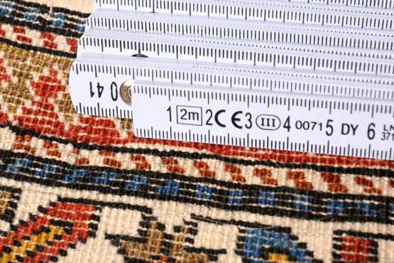 Perepedil mit typischem Wurma-Rapportmuster auf dunkelblauem Hauptmedaillon mit 2 oktogonalen Schildern, Tierabstraktionen, sternförmigen Blüten und weißer Kufi-Hauptbordüre, Ostaukasus, Region Kuba, 19.Jh., 126x190cm, F… - Foto 6