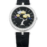 VAN CLEEF & ARPELS. A LADY`S ELEGANT 18K WHITE GOLD AND DIAMOND-SET BI-RETROGRADE WRISTWATCH WITH MOTHER-OF-PEARL - фото 1