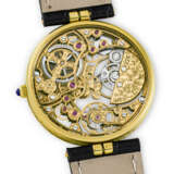 PATEK PHILIPPE. AN 18K GOLD SKELETONISED AUTOMATIC WRISTWATCH - photo 3
