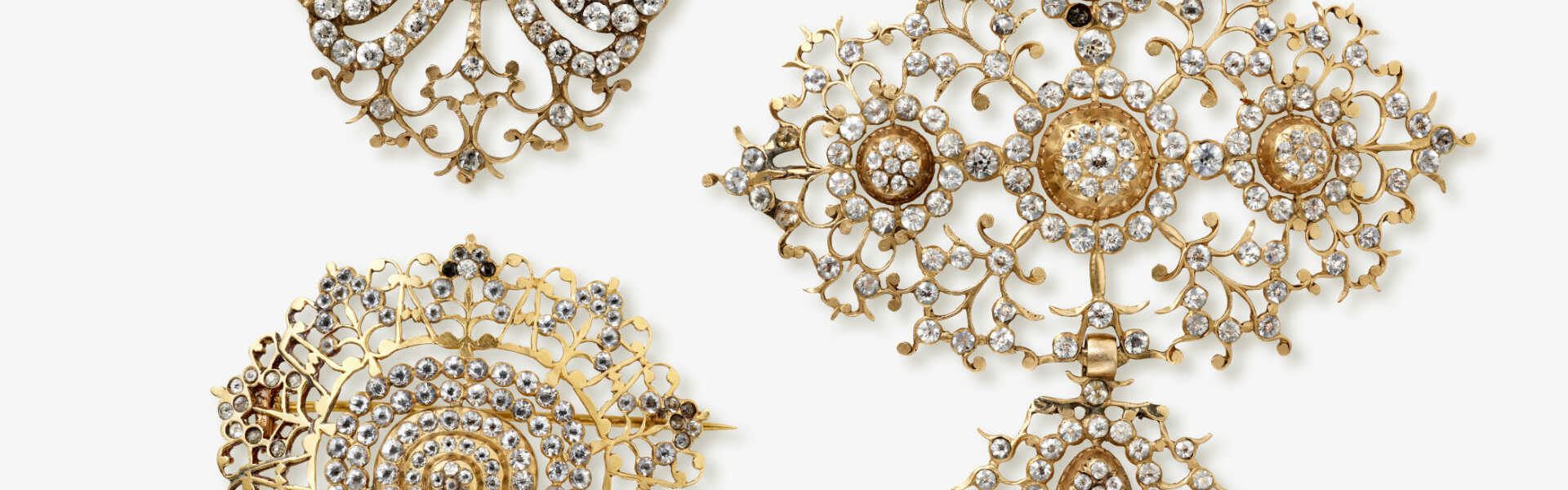 A cross pendant, clasp and brooch with rhinestones. Probably France, circa 1760