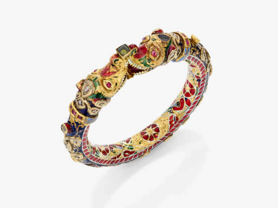 A bangle with dragon heads and diamonds, rubies, and enamel. India - photo 1
