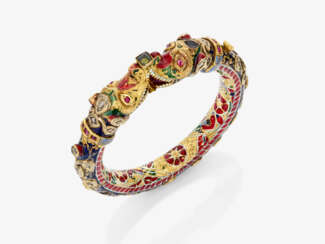 A bangle with dragon heads and diamonds, rubies, and enamel. India
