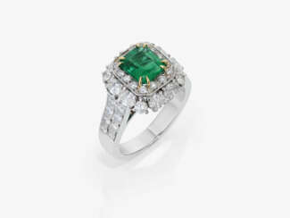 A ring with emerald and diamonds.