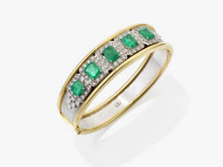 A bangle with emeralds and brilliant-cut diamonds.