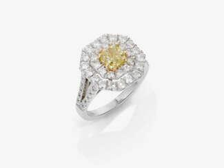A ring with yellow diamond and brilliant-cut diamonds.