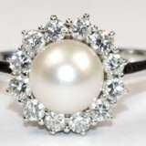Ring, 750er WG, besetzt mit 1 Perle, Dm. 0,8 cm, die von 12 Brillanten von zus. ca. 0,48 ct. umrandet wird, Ges.-Gew. 5,04 g, RG 61,5 - photo 1