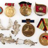 Konvolut von 14 Orden und Abzeichen, DDR, u.a. "Für treue Dienste NVA", in Gold und Silber, "60 Jahre Roter Oktober", "20. Jahrestag Demokratische Bodenreform" - Foto 1