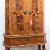 Barock-Stollenschrank, Nußbaum, Fußgestell mit 4 verstrebten gewundenen Säulen und 1 Schublade teilweise ergänzt, 2-türiger, intarsierter Aufsatz, innen 2 Einlegeböden und 2 Schubladen, leichte Furnierschäden, schleifenb… - Foto 1