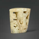 A RARE MOTTLED GREYISH-BEIGE JADE `WINGED DRAGON` CHAPE - photo 3