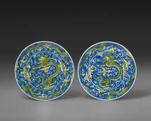 A PAIR OF YELLOW-ENAMELED BLUE-GROUND &#39;DRAGON&#39; DISHES