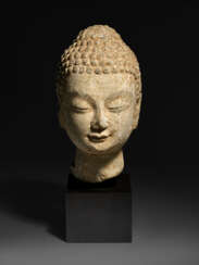 A SMALL LIMESTONE HEAD OF BUDDHA