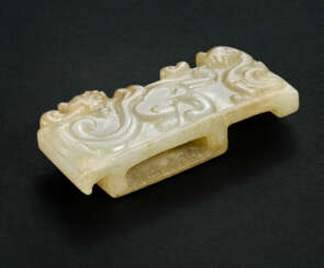 A RARE AND FINELY CARVED PALE GREYISH-WHITE AND BEIGE JADE SCABBARD SLIDE