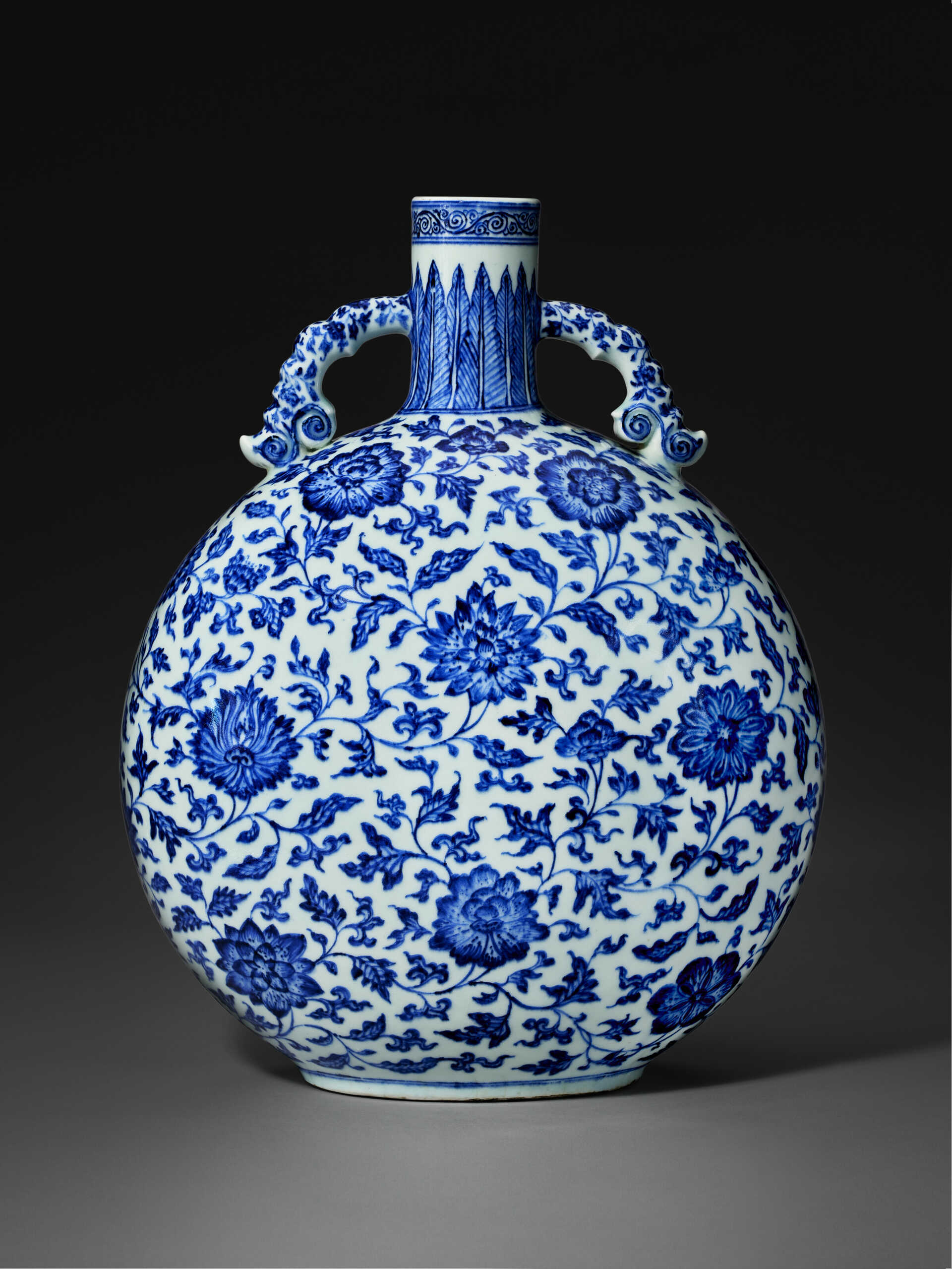 A VERY RARE BLUE AND WHITE 'FLORAL SCROLL' MOON FLASK A VERY RARE BLUE AND WHITE 'FLORAL SCROLL' MOON FLASK