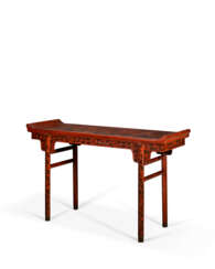 A POLYCHROME-DECORATED RED LACQUER RECESSED-LEG TABLE