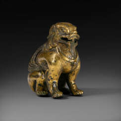 A GILT-BRONZE FIGURE OF A SEATED MYTHICAL BEAST