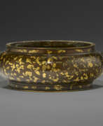 Bronze. A GOLD-SPLASHED BRONZE BOMB&#201; CENSER WITH LION-MASK HANDLES