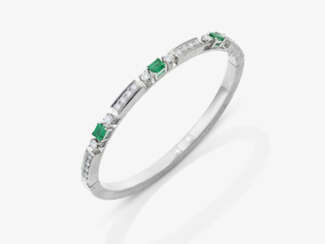 A bangle with emeralds and brilliant-cut diamonds