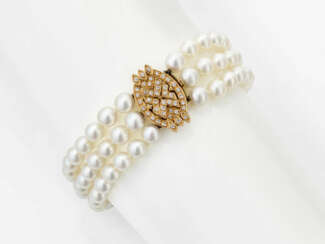 A three-strand Akoya cultured pearl bracelet with diamond-studded clasp