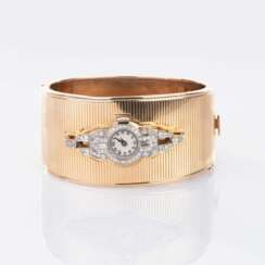 Art-déco Diamant-Uhr an Gold-Armreif.