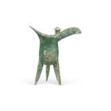 AN ARCHAIC BRONZE TRIPOD RITUAL WINE VESSEL, JUE - photo 4
