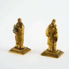 TWO SMALL COPPER FIGURINES OF SAINT FRANCIS AND A SAINT WITH A MODEL OF A CHURCH