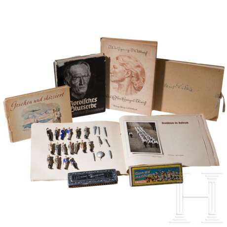 A group of books, WHW figures, postcards and a harmonica in a case - photo 1