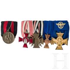 A 4-piece medal bar of a long-serving police officer, with a single medal bar