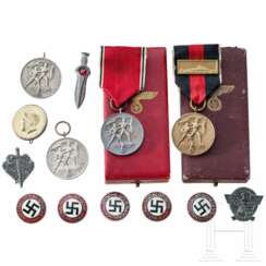 A collection of unworn party badges, commemorative medals and WHW badges