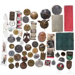 A collection of badges, tinnies, WHW badges, cases of issue, and a Carinthia commemorative medal